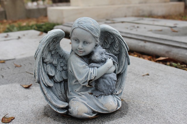 Mortuary Statue of angel and rabbit hugging